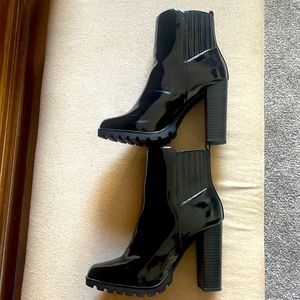 Worn once paten leather boots.